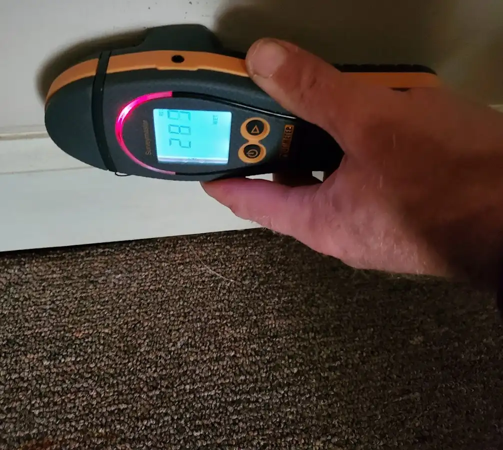 Moisture detection at baseboard during Storm Damage Restoration in Cumberland